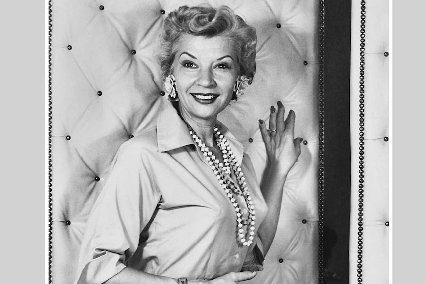 A black and white image of a glamourous 1950s woman. 