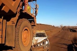 A mining truck at Rio Tinto's Brockman 4 mine in the Pilbara almost crushes a 4WD. July 30, 2014