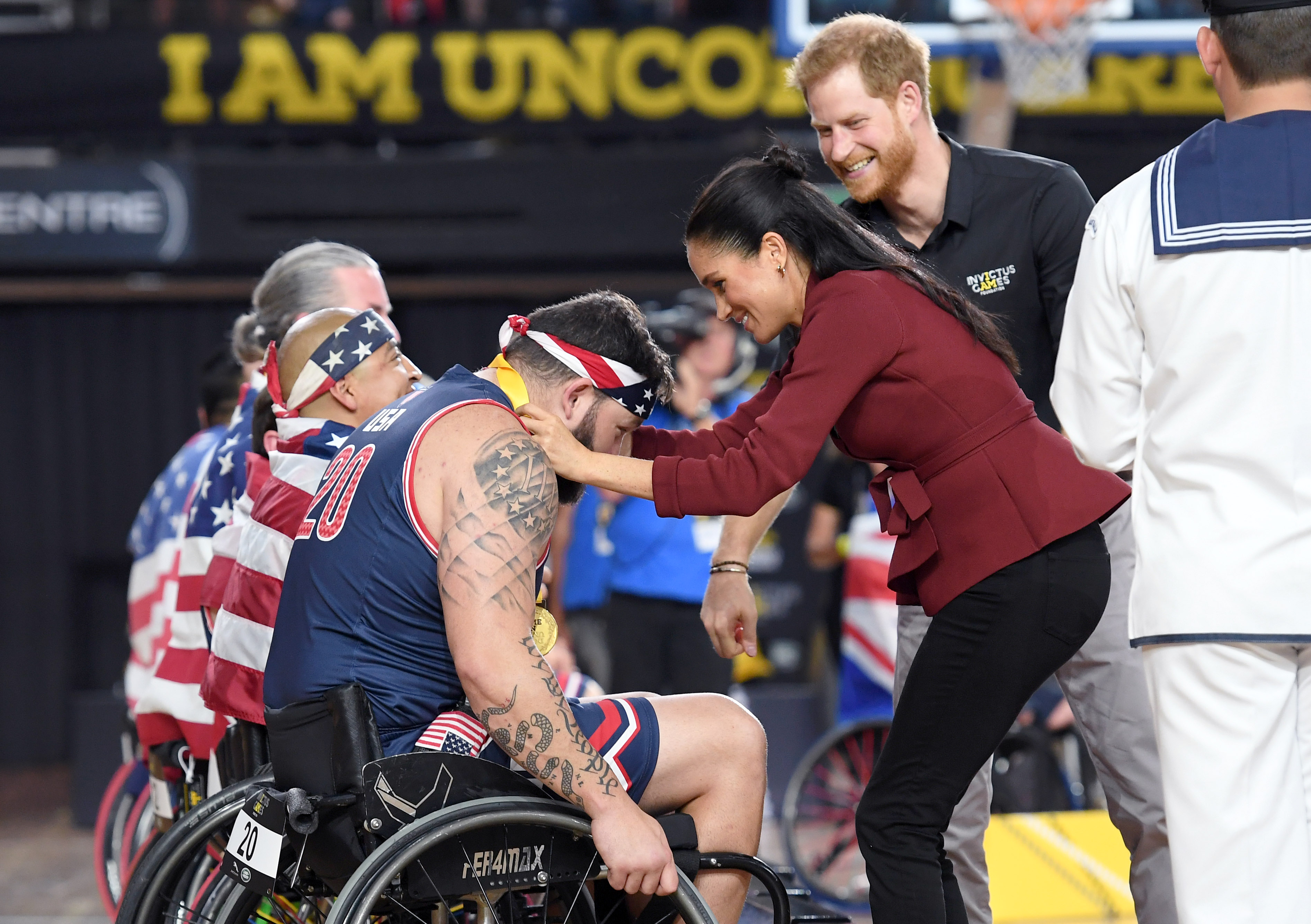 Meghan Markle puts medal on wheelchair athlete