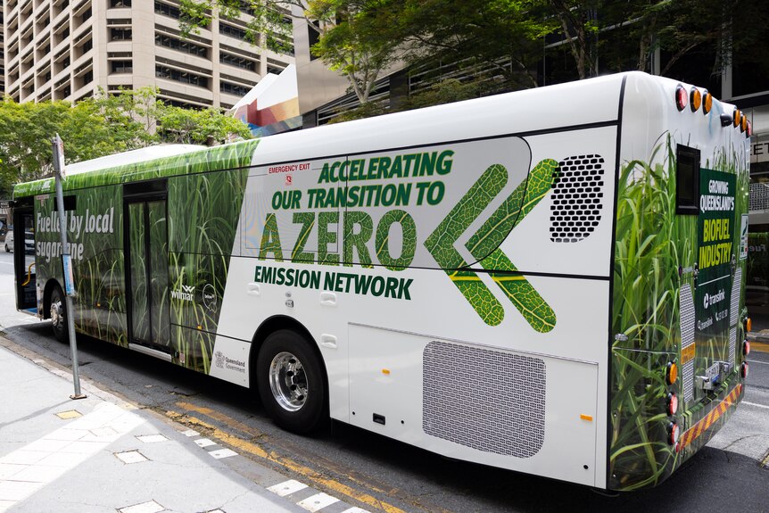A bus with green writing saying "Accelerating our transmission to zero emissions" on the side.