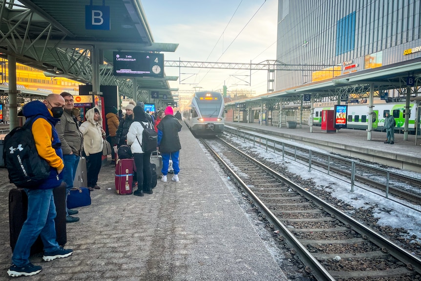 Passengers wait for the train at a platform in Helsinki.