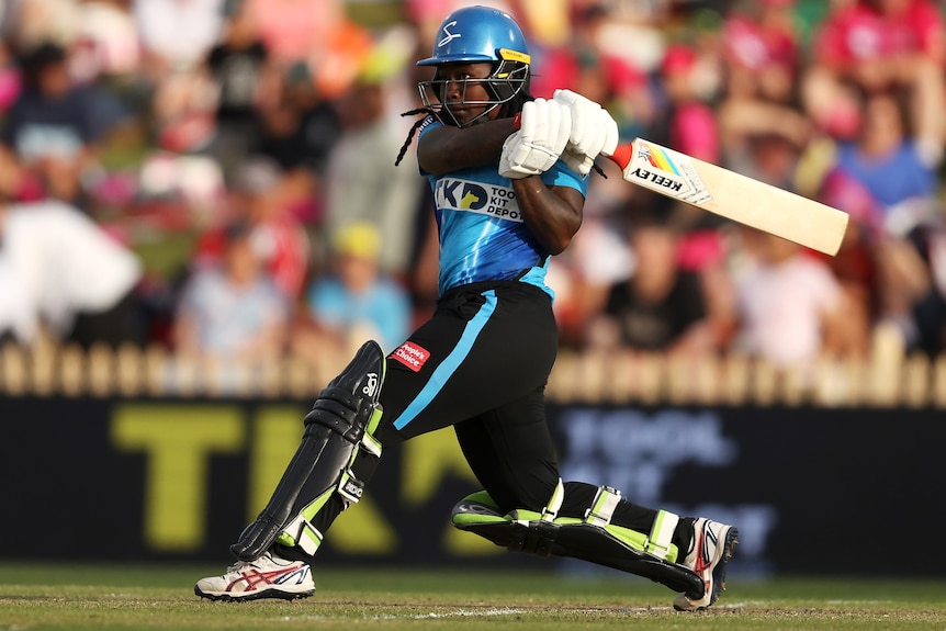 An Adelaide Strikers WBBL players hits out to the leg side against Sydney Sixers.