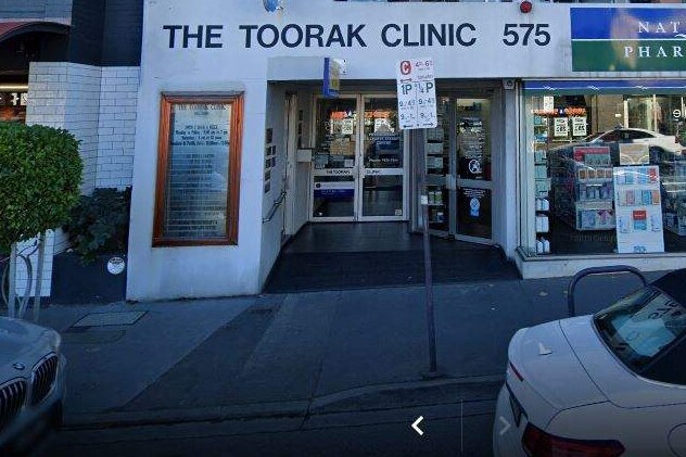 A white building with signage that reads "The Toorak Clinic", with pharmaceutical goods in the shop front.