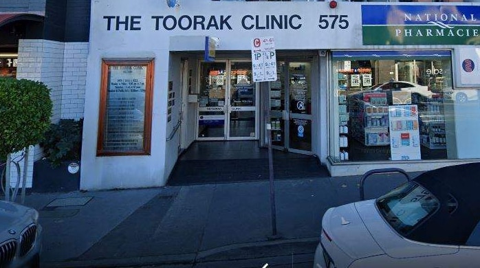 A white building with signage that reads "The Toorak Clinic", with pharmaceutical goods in the shop front.