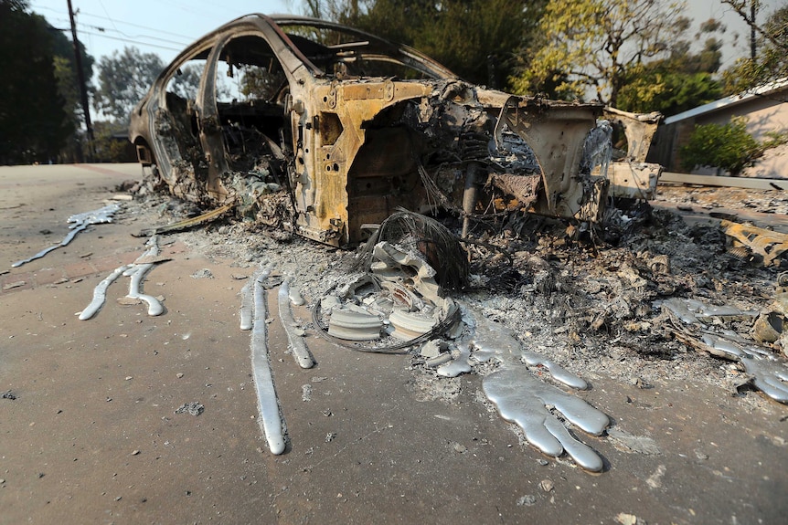 Molten aluminium is seen after flowing from a car that burned on a road