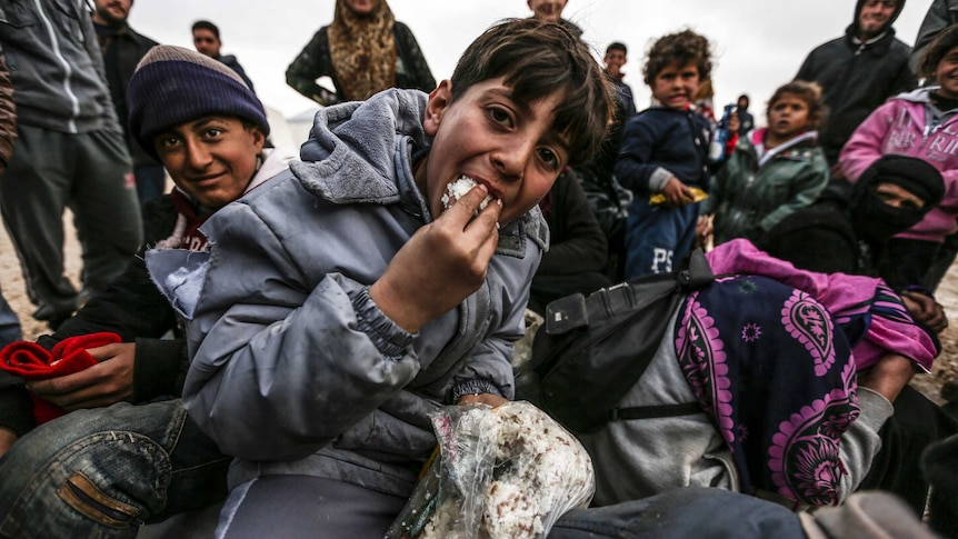 Syrian asylum seekers are pictured in a camp near the Turkish border.