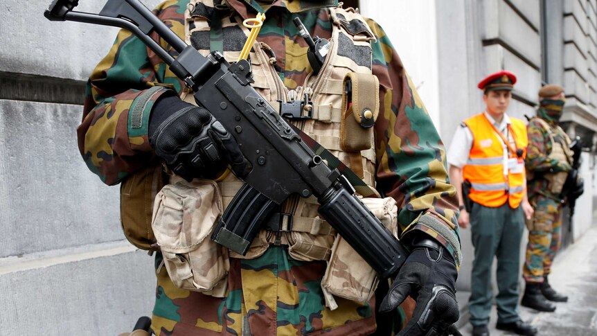 A Belgian soldier stands guard outside the PM's office building during a meeting of the government's security council.