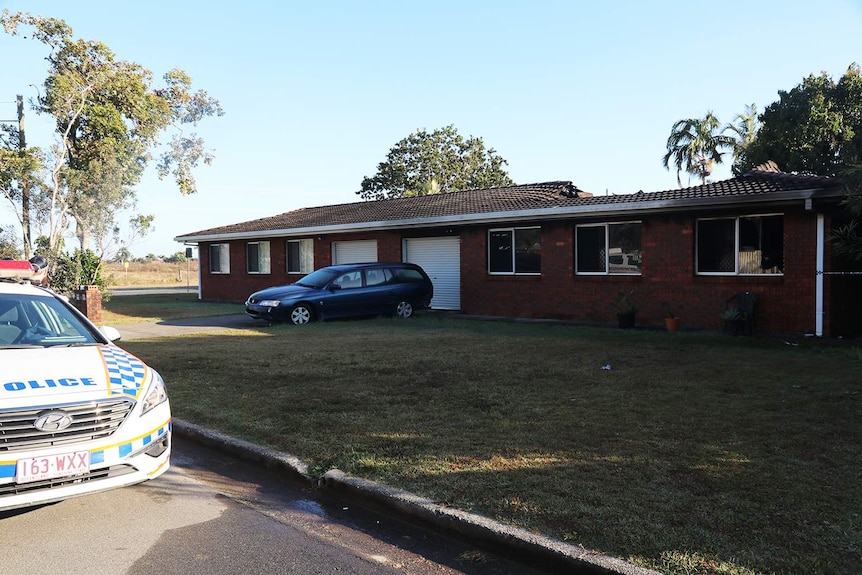 Police car outside fire-damaged duplex house at Fisher Street in Bucasia in Mackay.