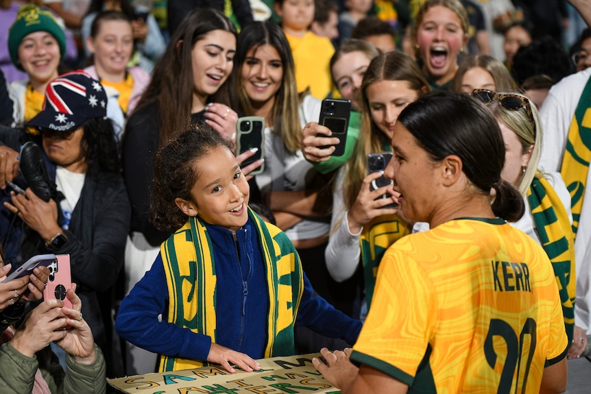 Matildas star Sam Kerr meets an excited fan. 
