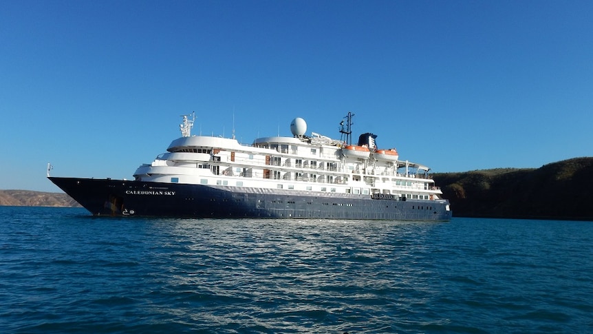 A luxury cruise on the ocean ship beneath a clear sky.