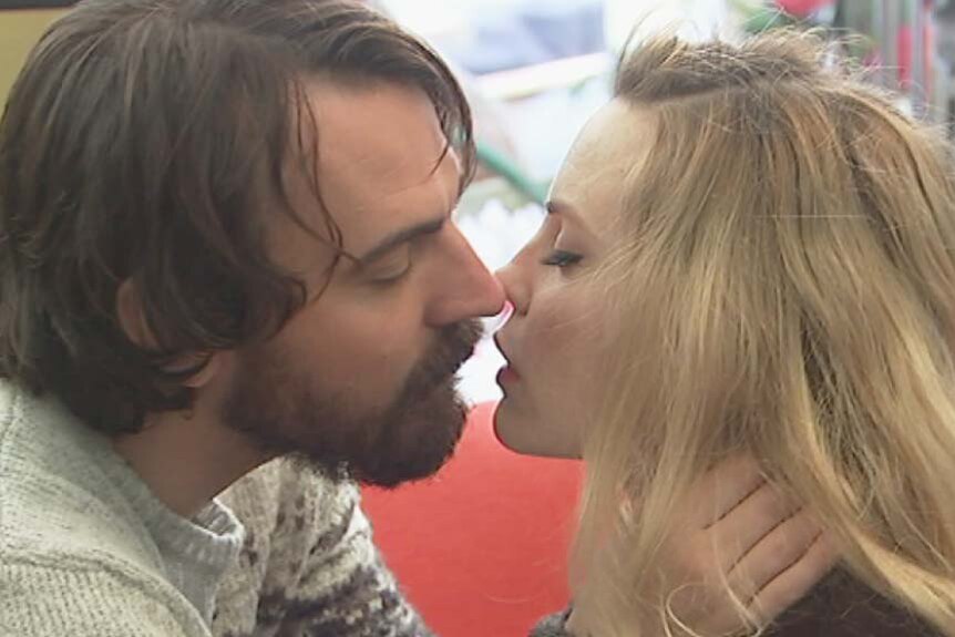Actors Ewen Leslie and Melissa George kiss in a scene from the movie