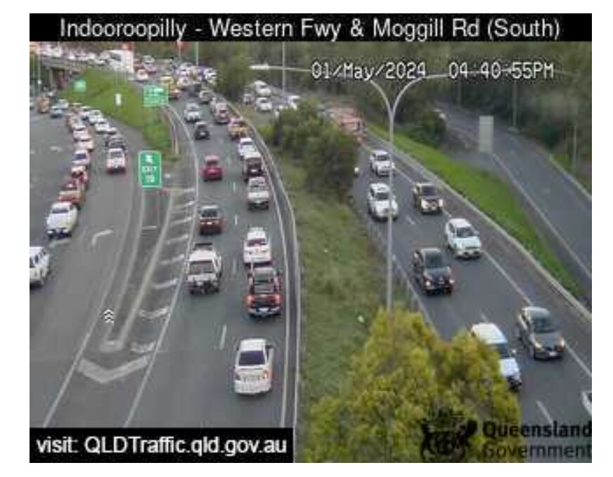 An areal shot of a highway with an exit ramp showing traffic jams