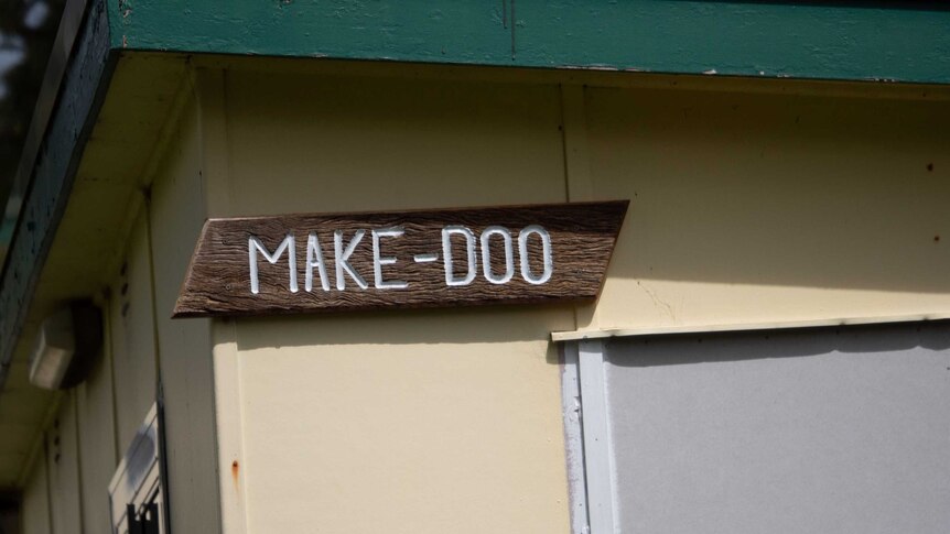 A wooden sign with the name etched into it.