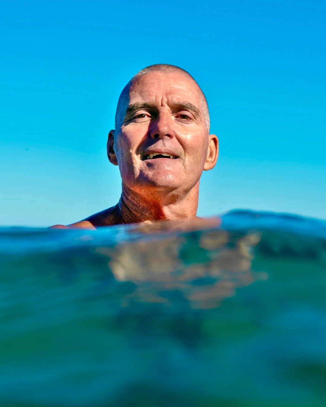 Scott Cameron swims in the ocean