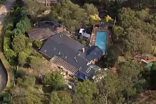 An aerial view of a house with a pool.