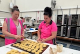 Workers make dog treats at a factory in Melbourne.