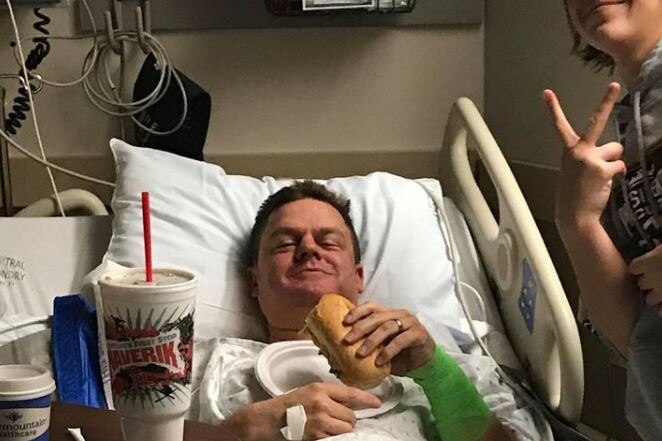 Cade Brenchley enjoys fast food in his hospital bed.