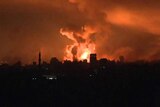 Large explosion of orange lights up the skyline in gaza at night