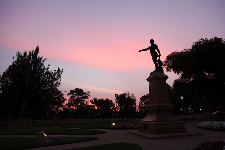 Statue of Colonel William Light in Adelaide with sunset colours in the sky
