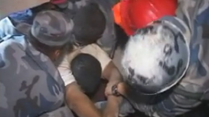 Man being pulled from rubble in Nepal