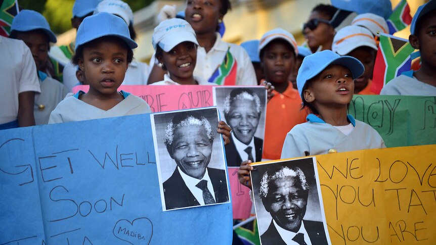 South African children hold messages of support for Nelson Mandela