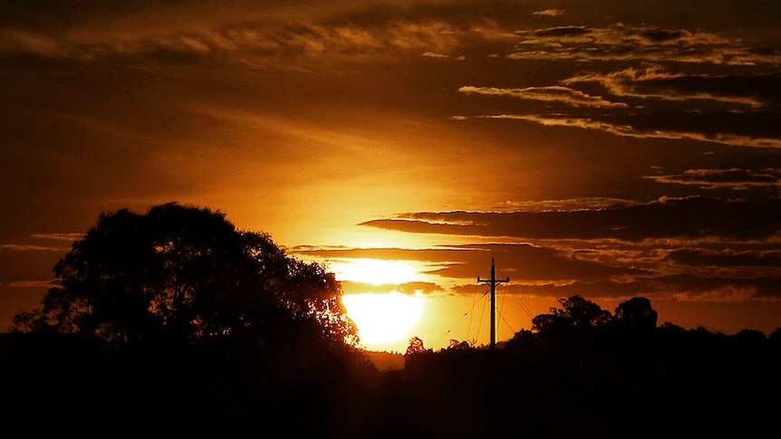 The sun rises over suburban Canberra.