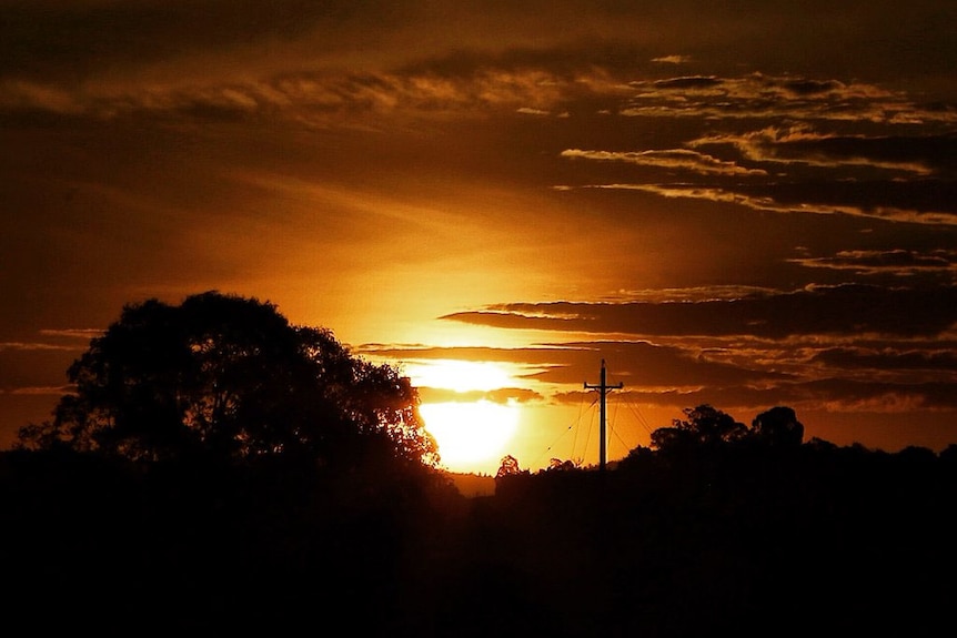 The sun rises over suburban Canberra.