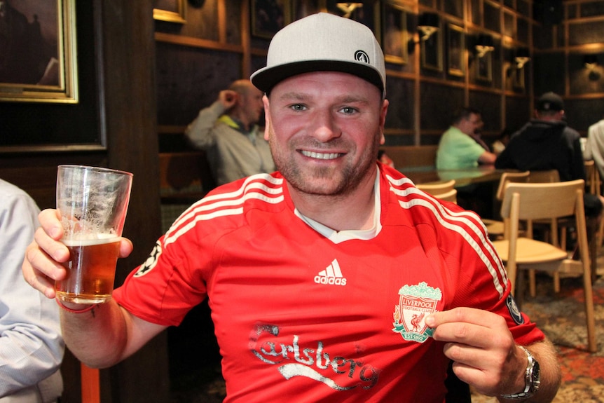 David wearing a Liverpool jersey.