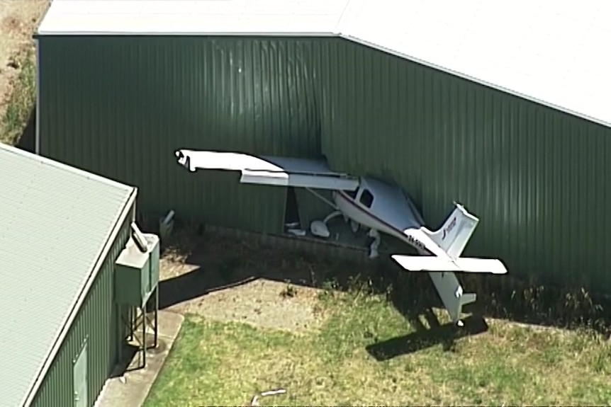 A white light plane embedded into a green hangar