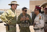 Colonel Andrew Lowe and Private Ramy Nakhil chat with Staff Brigadier General Wisam Abdul Aziz Al Sa'edi.