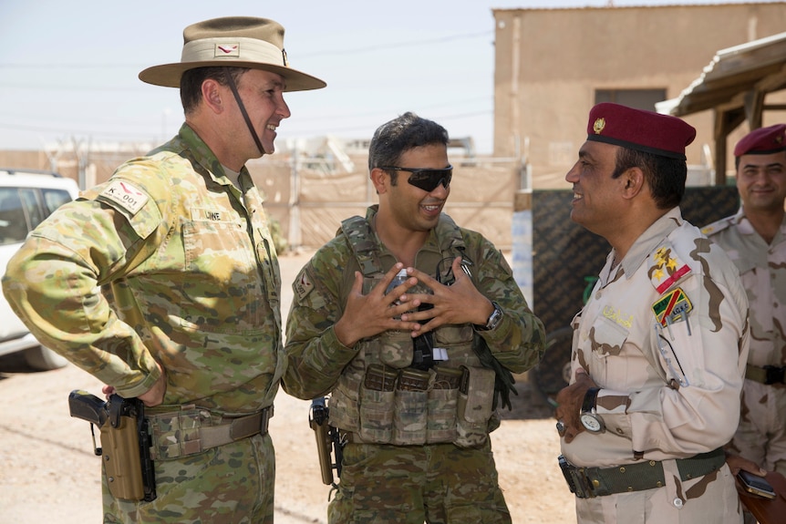 Colonel Andrew Lowe and Private Ramy Nakhil chat with Staff Brigadier General Wisam Abdul Aziz Al Sa'edi.