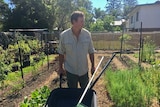 Biologist James Stanistreet in his garedn with his wheelbarrow and tools