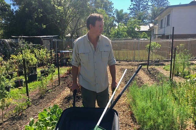 Biologist James Stanistreet in his garedn with his wheelbarrow and tools