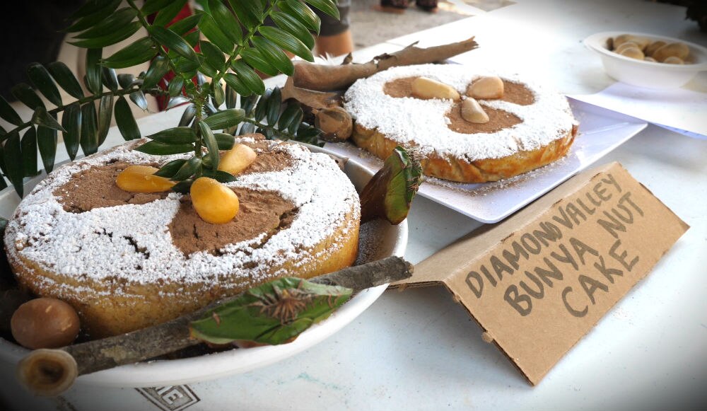 two cakes on a table with bunya nut decorations