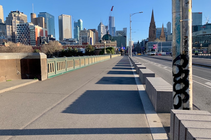 The footpath along Princes Bridge is empty in the winter morning sunlight, viewed from Southbank end.