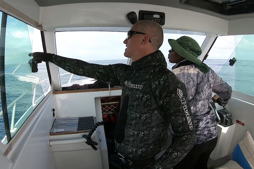 Two scientists in a boat spot a whale shark off the West Australian coast near Exmouth.