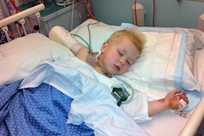 Toddler lying in a hospital bed