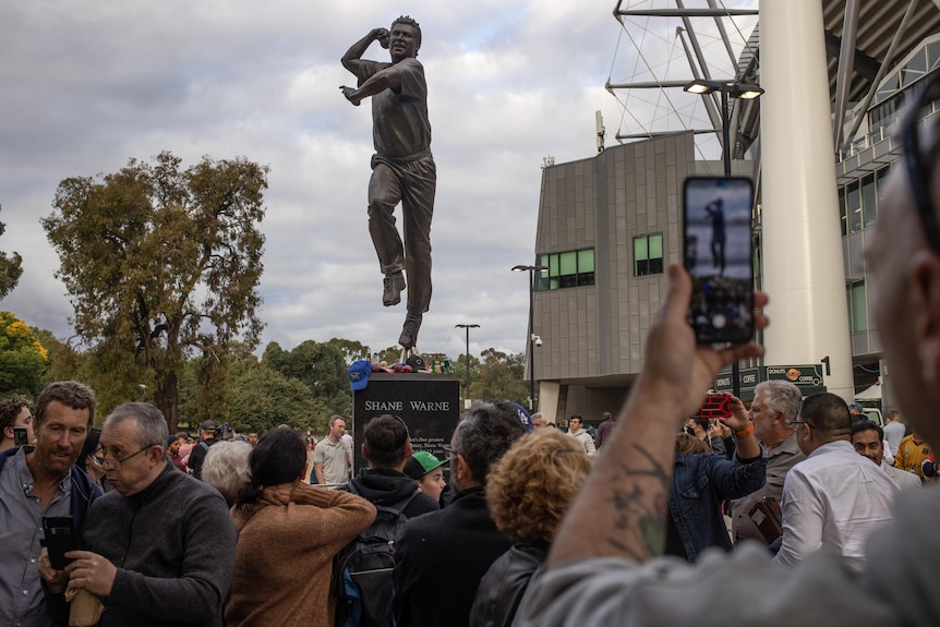 Crowds around Shane Warne's statue ahead of his memorial at the MCG.