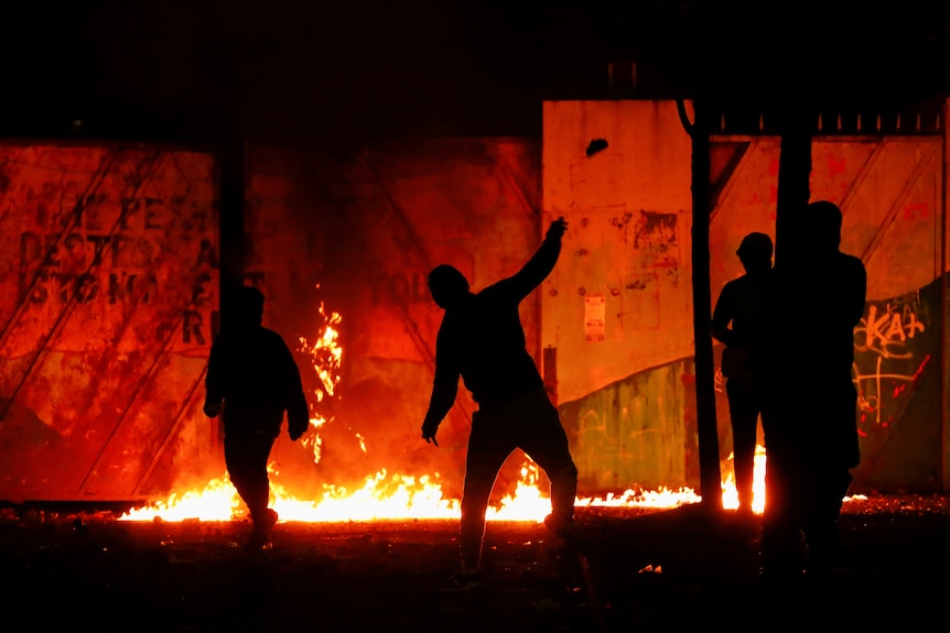 Rioters at night.