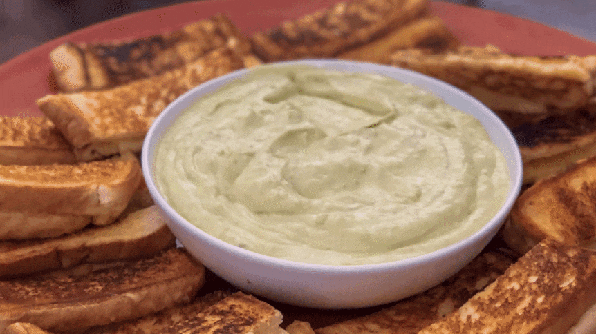 Gif of a hand dipping grilled cheese toastie into a saucer of jalapeno cream from our recipe.