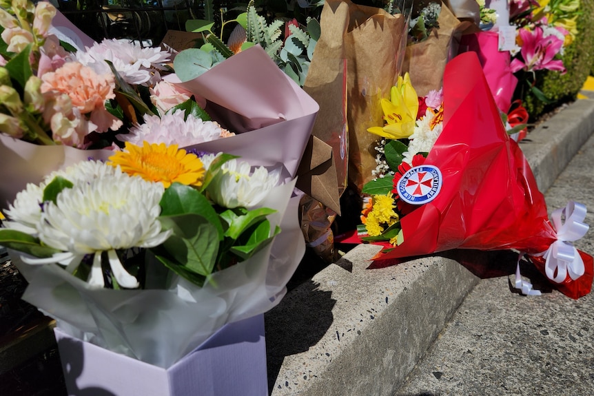 flowers on the footpath outside a venue where a man was killed