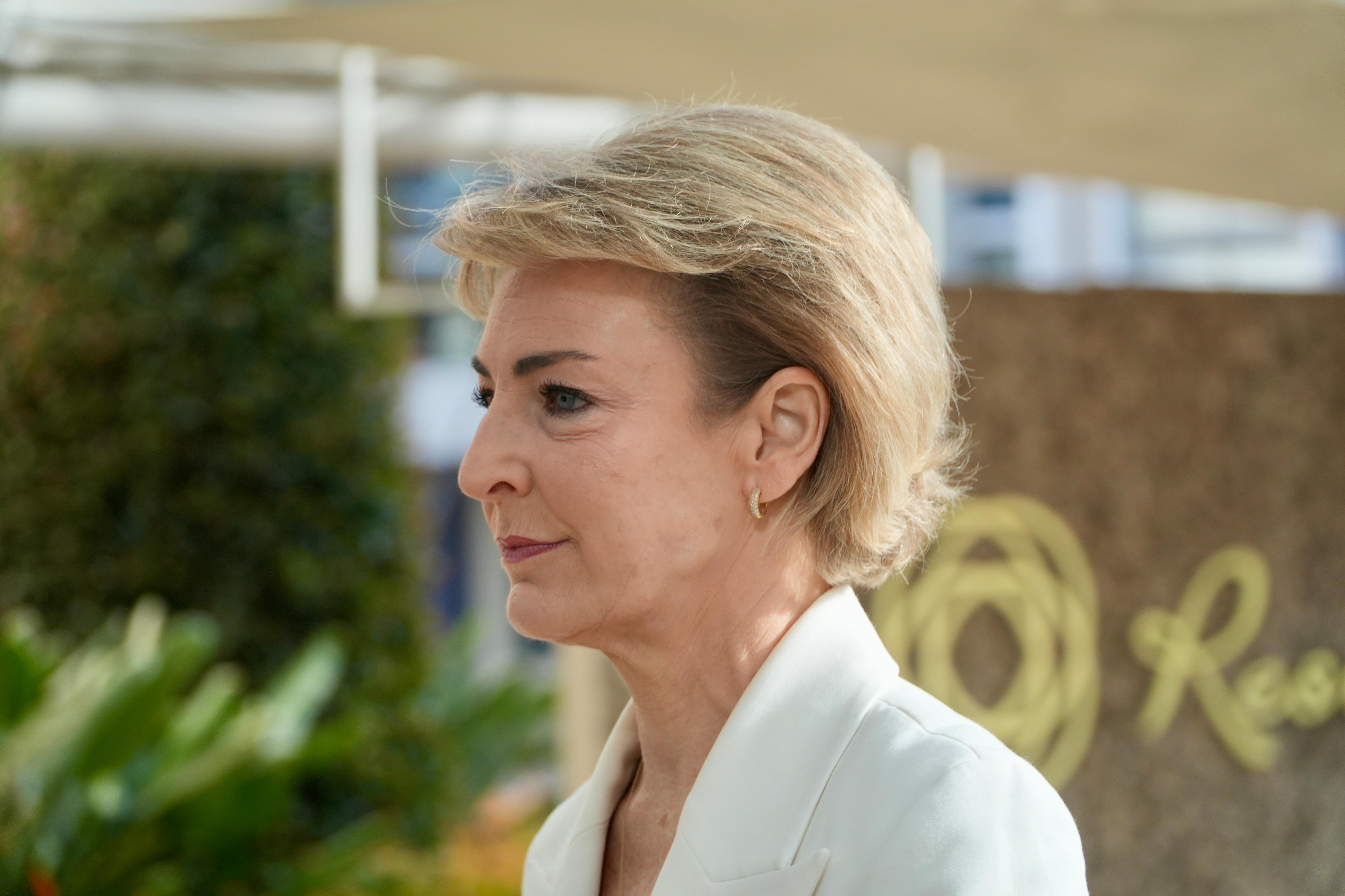 A side close-up shot of Michaelia Cash wearing a white jacket