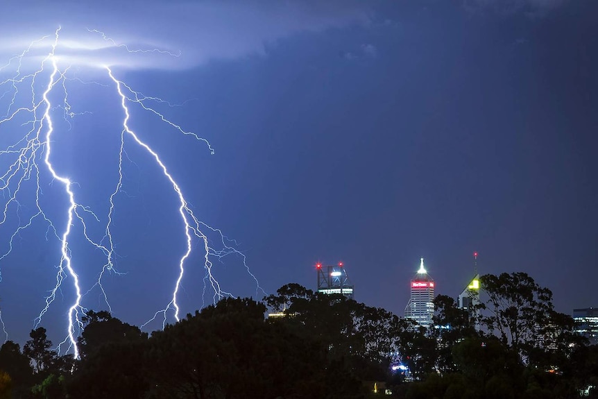 Lightning strikes over the Perth CBD at night.