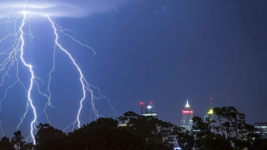 Lightning strikes over the Perth CBD at night.