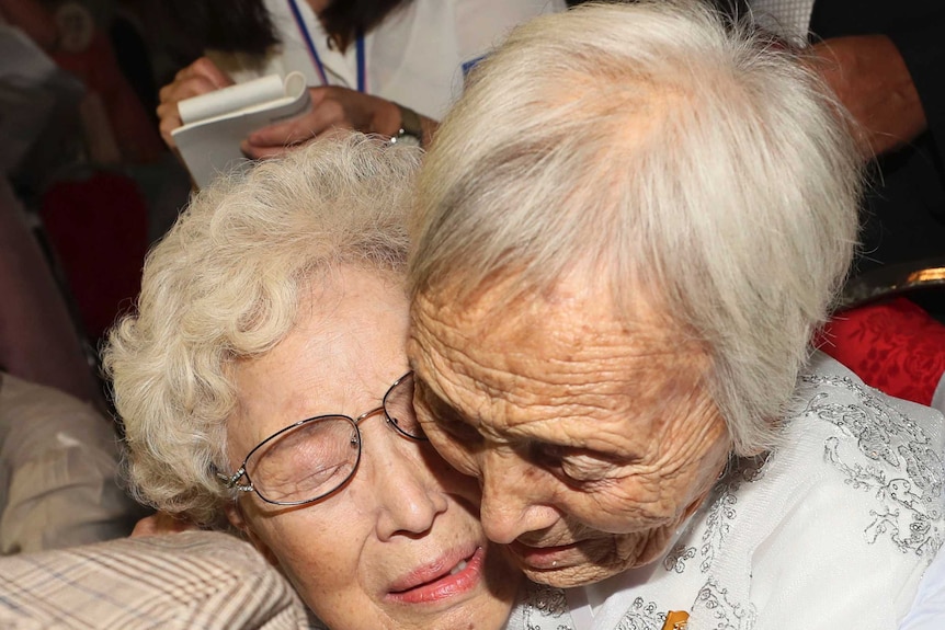 South Korean Cho Hye-do, 86, center, hugs her North Korean sister Cho Sun Do, 89, right, at the reunion.