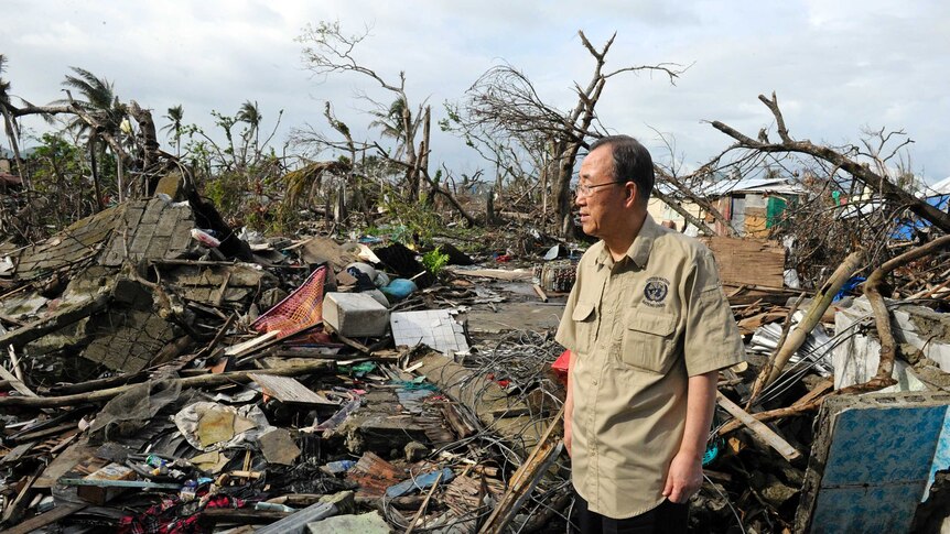 In this image released by the United Nations, UN secretary-general Ban Ki-moon tours a devastated area of Tacloban City.