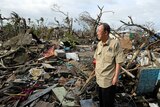 In this image released by the United Nations, UN secretary-general Ban Ki-moon tours a devastated area of Tacloban City.
