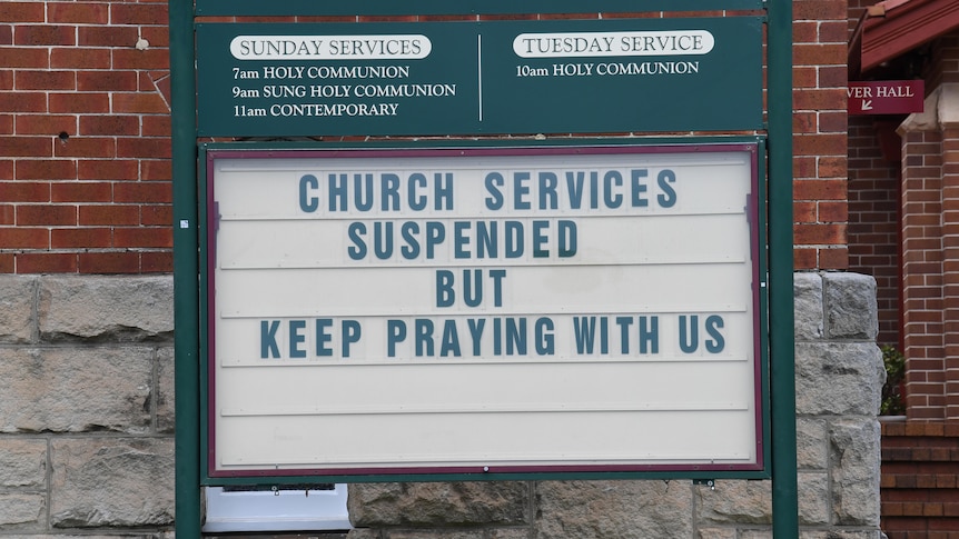 A church billboard reading: "Church services suspended but keep praying with us."