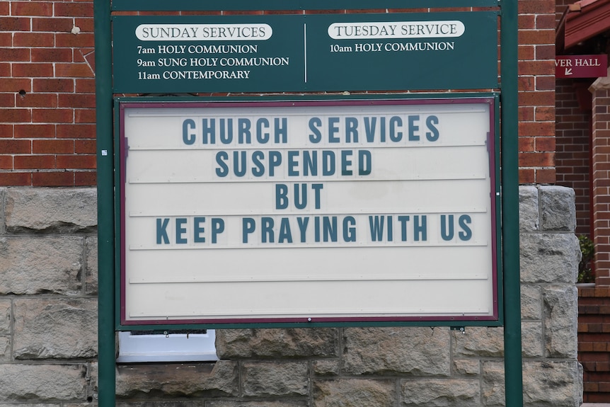 A church billboard reading: "Church services suspended but keep praying with us."