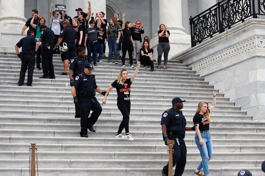 Activists are arrested by Capitol Hill Police officers after occupying the steps on the East Front of the U.S. Capitol